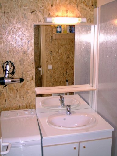 Badkamer met badmeubel en wasmachine Badkamer met badmeubel en wasmachine